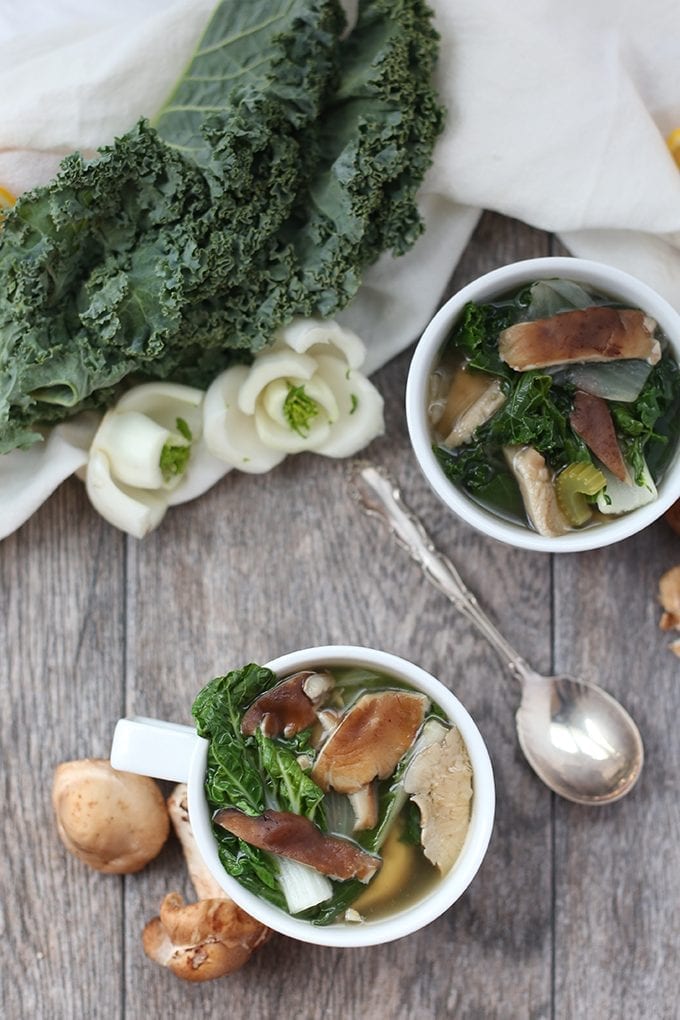 Overhead photograph of immune boosting soup with mushrooms, kale + bok choy.