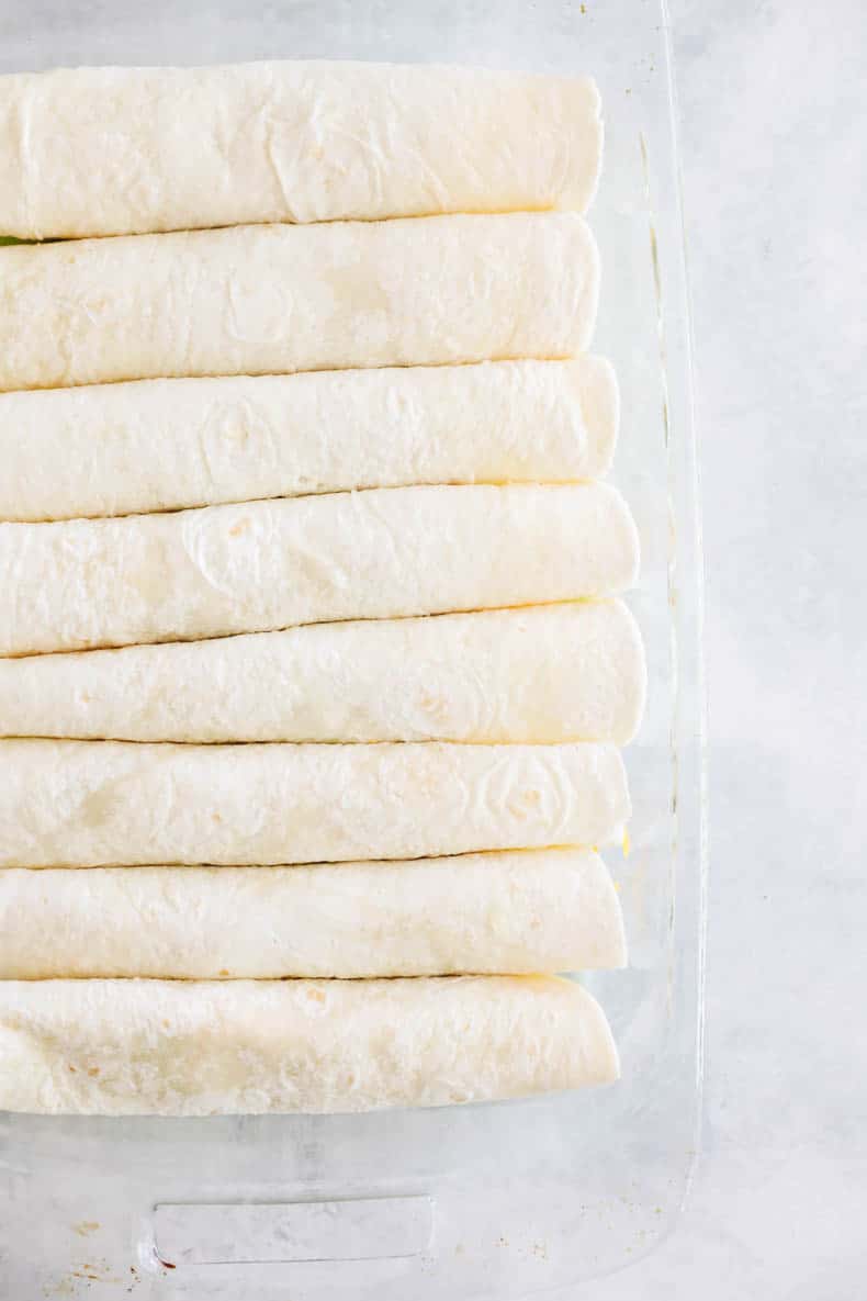 green chicken tortillas lined in a baking pan.