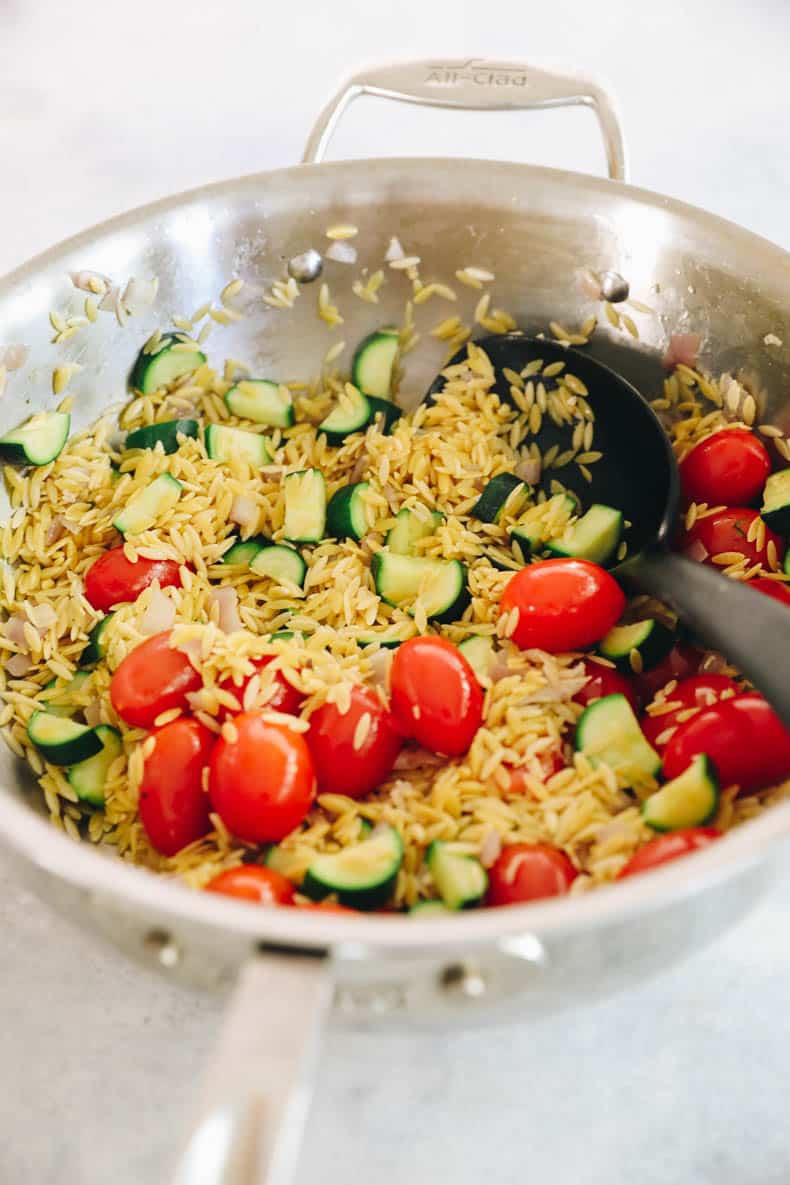 orzo, tomatoes, zucchini in a pot