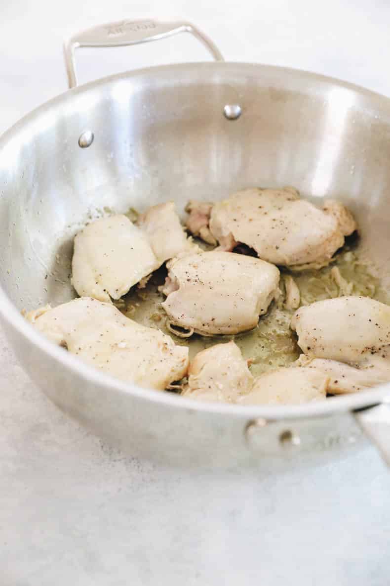 cooked chicken thighs in a pot