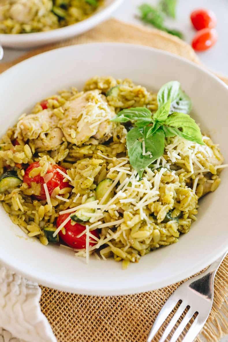 one pot pesto chicken and orzo in a white bowl
