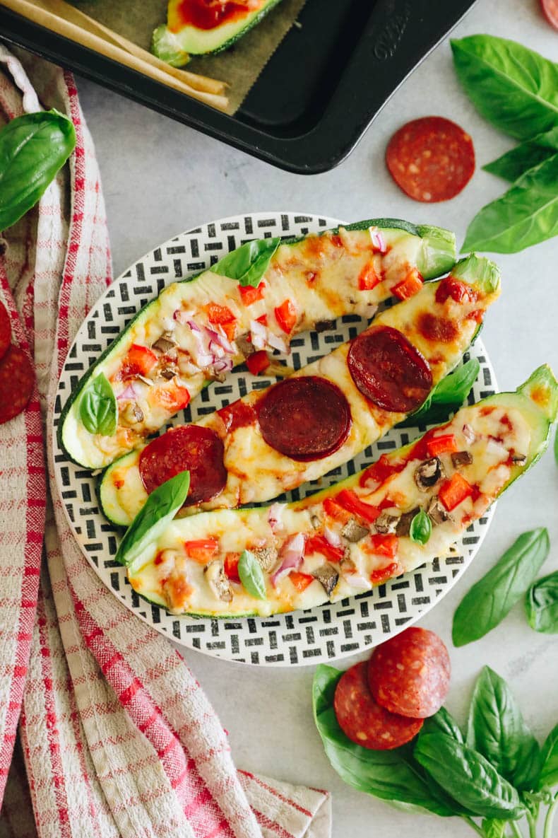 Overhead image of zucchini pizzas.