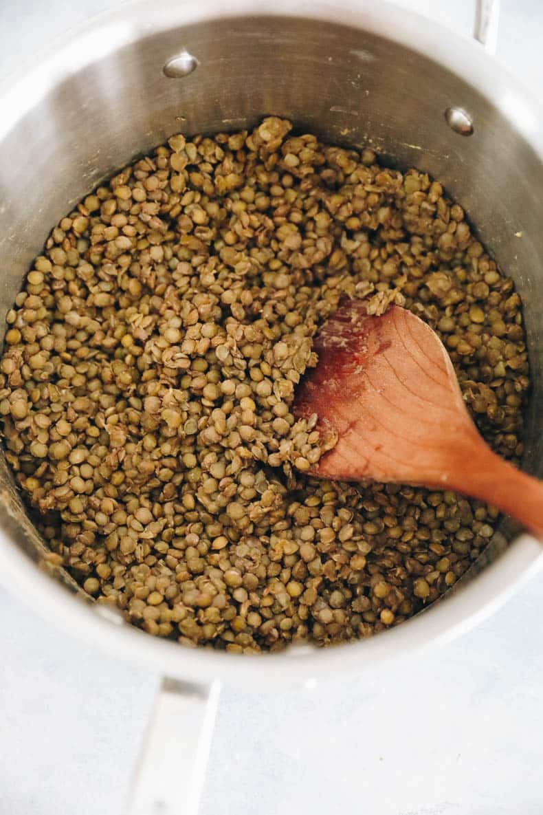 Cooked french lentils in a pot.